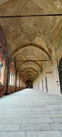 A long, arched cloister or arcade with stone pavement and vaulted ceilings. This historic...