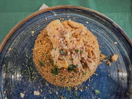 Seafood dish served on a modern blue plate. Garnished with fresh herbs.の写真素材