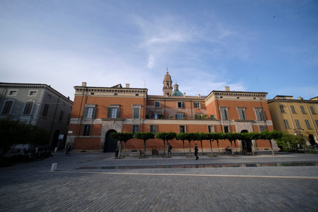 A view of Palazzo Rangone in Reggio Emilia, Italy, with its characteristic ocher color and tower.