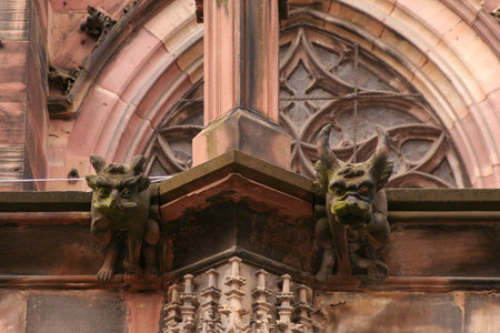 A close-up shot featuring two gargoyles at Strasbourg Cathedral, highlighting the stone details and Gothic architecture. High quality photoの写真素材