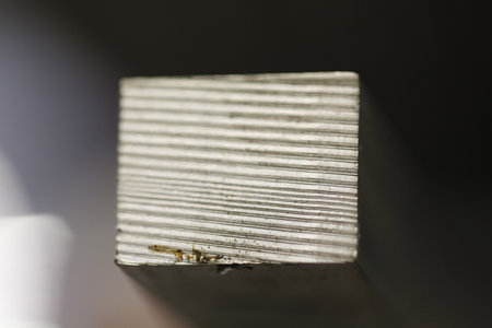 A square block showing a visible grain texture is centrally framed against a dark background, highlighting the natural material's detail. High quality photoの写真素材