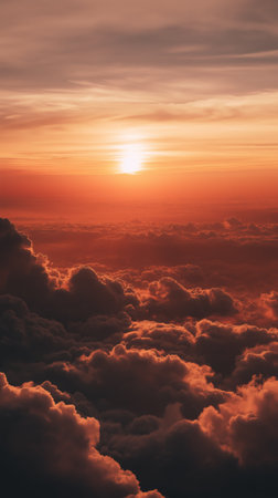 Stunning high-altitude perspective of colorful clouds illuminated by the warm light of a sunset or sunrise. High quality photoの素材