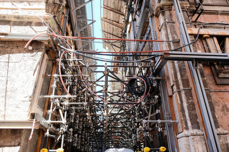 Extensive scaffolding and support structures fill the interior of a historic building in L'Aquila,...