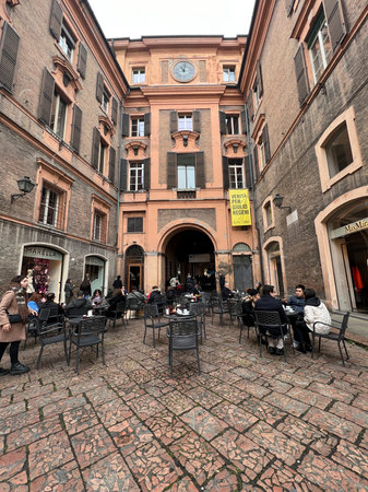 Modena, Italy : 2023 01 01 A bustling scene in a historic street, with people walking along a...