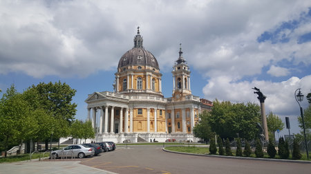 The stunning exterior of the Basilica of Superga, a Baroque masterpiece with a grand dome and bell towers, standing under a cloudy sky in Turin, Italy. High quality photoの写真素材