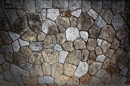 Stone wall with a spotlight in the centerの写真素材