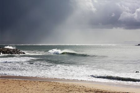 Perfect waves for surfing in Carcavelos beachの写真素材