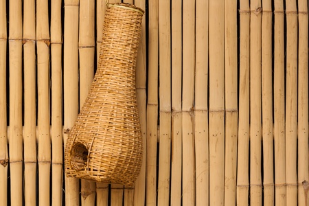 Bamboo eel trap norther Thai style hanging on bamboo wallの写真素材