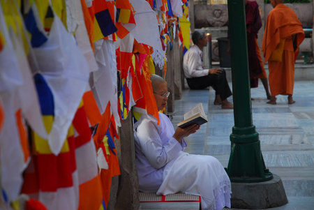 Bodh Gaya, India - April 5, 2013 - Unidentified Buddhist nun praying at the Maha Bodhi temple...