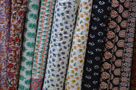 Stacks of cloth with colorful block prints in floral patternsの写真素材