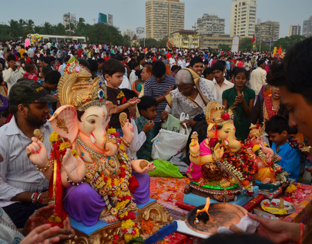 Mumbai, India - September 2013 - Devotees bringing Hindu God Ganesha into the ocean for immersionのeditorial素材