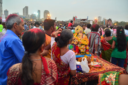 Mumbai, India - September 2013 - Devotees bringing Hindu God Ganesha to the ocean for immersion