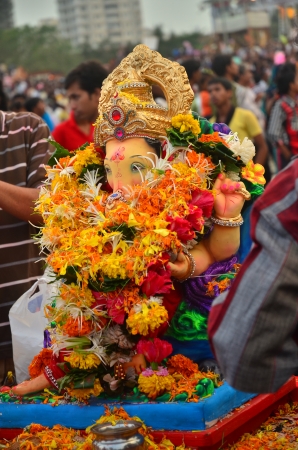 Mumbai, India - September 2013 - Hindu God Ganesha decorated with colorful flowers and garlands for immersion into the oceanのeditorial素材