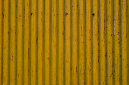 Sheet of metal wall texture, background in yellow colorの写真素材