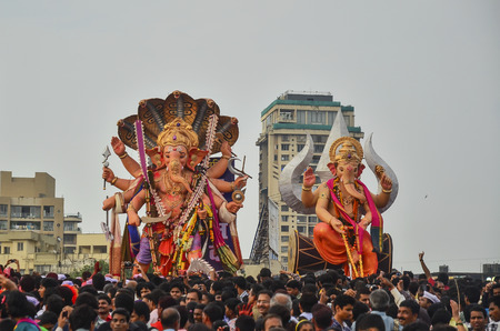Mumbai, India - September17, 2013 - Devotees bringing Hindu God Ganesha into the ocean during Ganesha Festivalのeditorial素材
