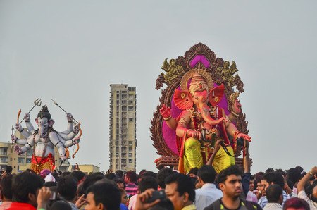 Mumbai, India - September17, 2013 - Devotees bringing Hindu God Ganesha into the ocean during Ganesha Festivalのeditorial素材