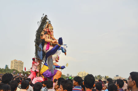 Mumbai, India - September17, 2013 - Devotees bringing Hindu God Ganesha into the ocean during Ganesha Festivalのeditorial素材