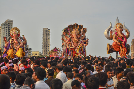 Mumbai, India - September17, 2013 - Devotees bringing Hindu God Ganesha into the ocean during Ganesha Festivalのeditorial素材