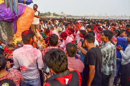 Mumbai, India - September17, 2013 - Devotees worshipping praying before bringing Hindu God Ganesha into the ocean during Ganesha Festivalのeditorial素材