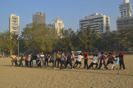 Mumbai, India - January 2014 - People playing Tug-of war game at Chowpatty Beach in the morning のeditorial素材
