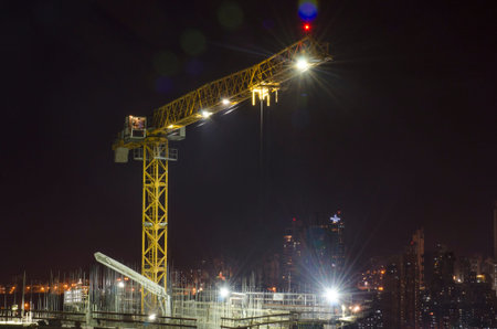 Crane on top of under construction building at night のeditorial素材