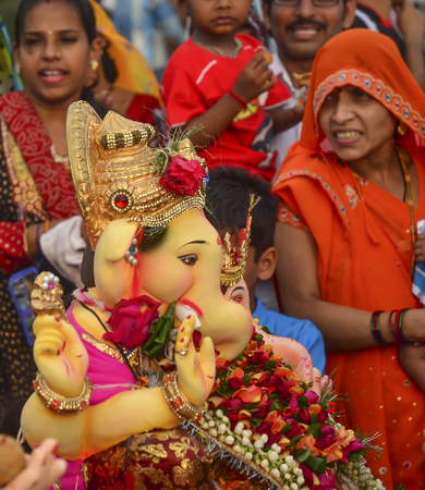 Mumbai, India - September17, 2013 - Devotees bringing Hindu God Ganesha into the ocean during Ganesha Festivalのeditorial素材