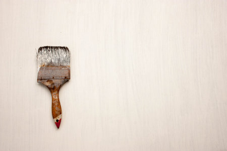 old paint brush on white wood background