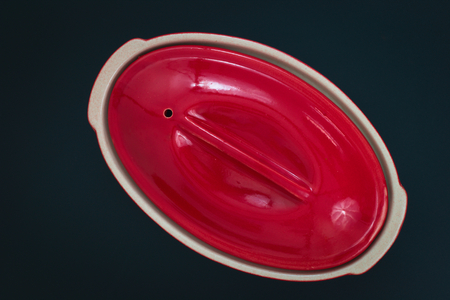 Red Ceramic bowl for oven on black backgroundの写真素材