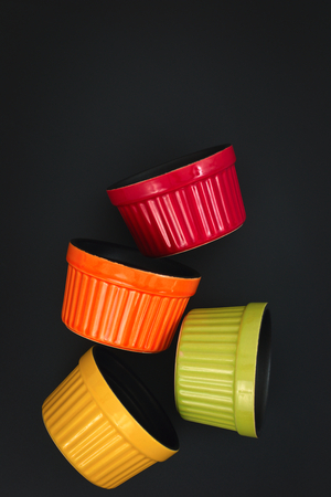 Colorful Ceramic bowl for oven on black backgroundの写真素材