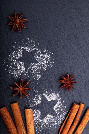 Background Christmas and New year Concept cinnamon and star anise on black slate stone backgroundの写真素材