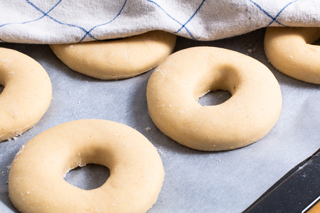 Baking concept Homemade cutting organic rising yeast dough with ground nutmegs for donuts の写真素材