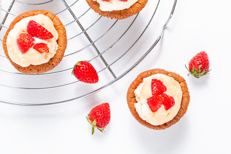 Food concept Fresh homemade strawberry whipped cream cupcake on white backfroundの写真素材