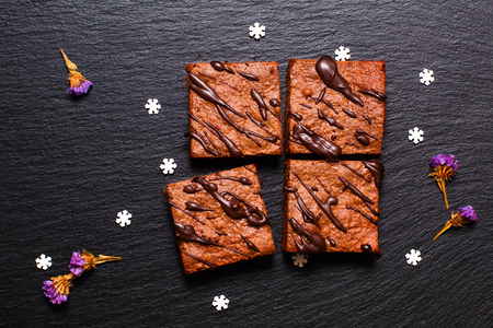 Food concept homemade organic brownies on black slate stone with copy spaceの写真素材