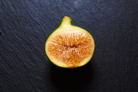 Food concept organic green Fig fruit on black slate stone plate with copy space