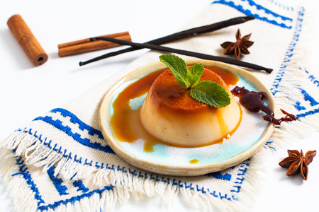 Food Dessert concept homemade vanilla Caramel custard or panna cotta with vanilla beans and spices on white backgroundの写真素材