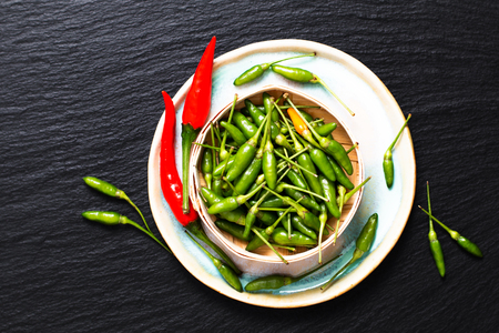 Food concept Chili Padi, Bird's Eye Chili, Thai pepper and red chili on bamboo tray with copy spaceの写真素材