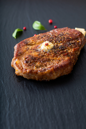 Food concept Marinated Sirloin meat steak on black slate stone plate with copy spaceの写真素材