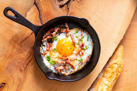 Food concept Fried egg and cheese bacon in cast iron skillet with copy spaceの写真素材