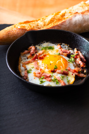 Food concept Fried egg and cheese bacon in cast iron skillet with copy spaceの写真素材
