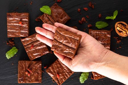 Food homemade Bakery concept Top view of Organic Brownies decorates by goji berry on black slate boardの写真素材