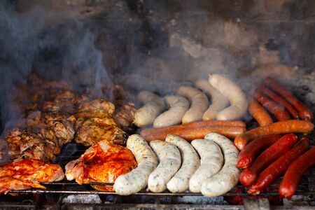 Summer life style concept Spot focus assortment barbecue meat and sausages grill in outdoor brick barbecueの写真素材