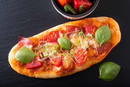 Food concept Homemade organic pizza with tomato, basil and ham with copy spaceの写真素材