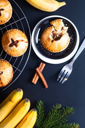 Food concept fresh baked Homemade Banana foster hand pie on black backgroundの写真素材