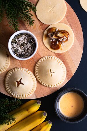 Food concept processing to make Homemade Banana foster hand pie on black backgroundの写真素材