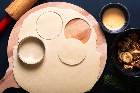 Food concept processing to make Homemade Banana foster hand pie on black backgroundの写真素材