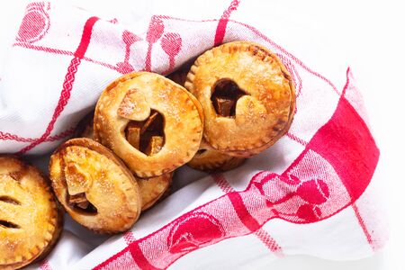 Food valentine idea concept fresh baked Homemade apple cinnamon hand pie on white backgroundの写真素材