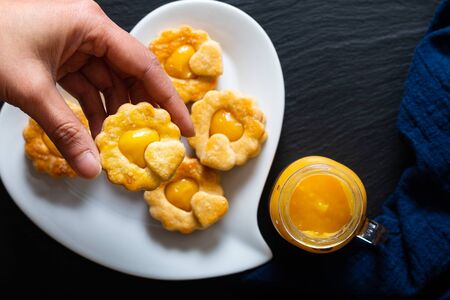 Valentine Holiday food idea concept homemade organic rustic lemon curd shortbread cookies on black background の写真素材