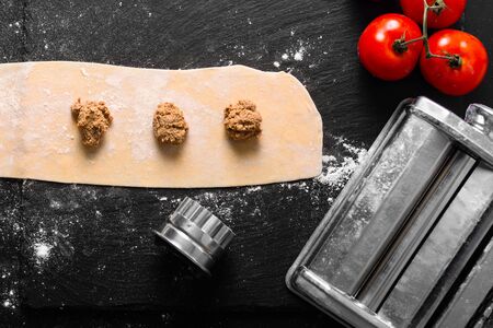 Food Concept home cooking Homemade organic ravioli pasta on black background with copy spaceの写真素材
