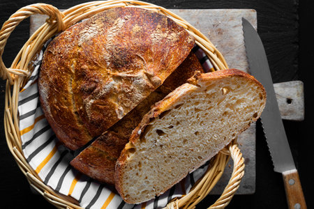 Home Cooking Homemade Organic Sourdough bread on black background with copy space
