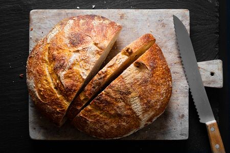 Home Cooking Homemade Organic Sourdough bread on black background with copy spaceの写真素材